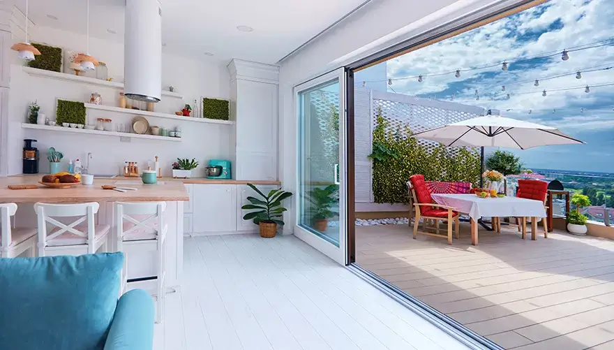 A sliding glass door opening onto a furnished balcony