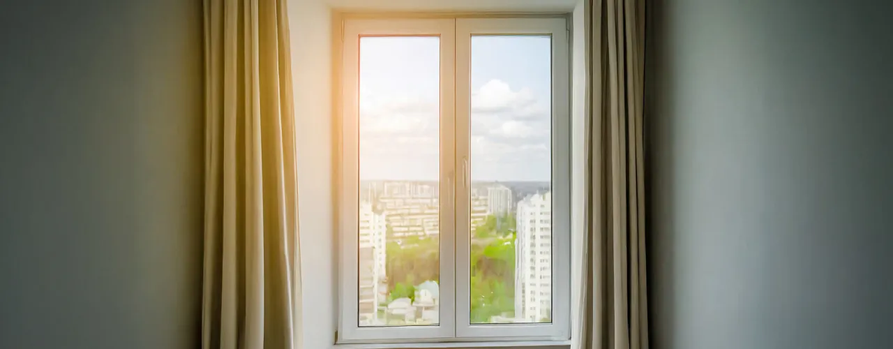 A uPVC French window with a city skyline view